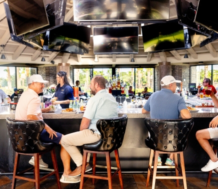 a group of people sitting at the bar at whitewater 360 sports club at horseshoe bay resort