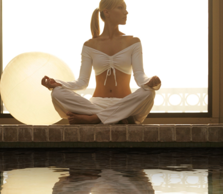 Woman doing lakeside yoga at Horseshoe Bay Resort