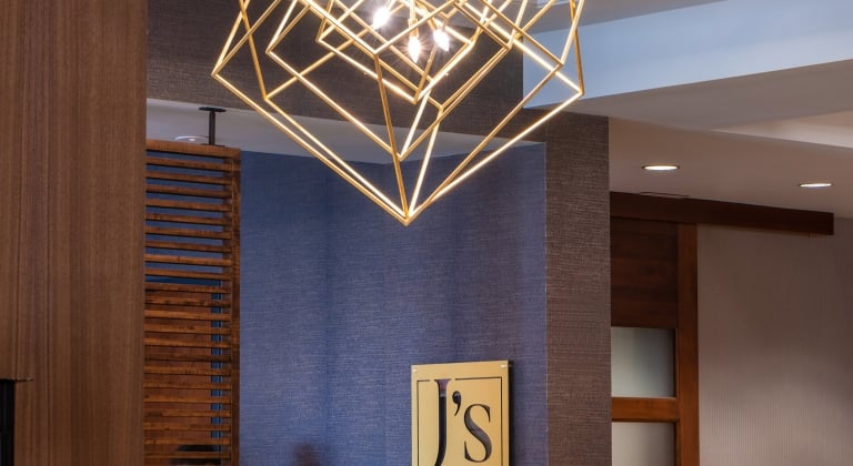 Hotel lobby with J logo on wall
