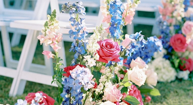 Texas Hill Country wedding venue at Horseshoe Bay Resort. White chairs with colorful flowers.