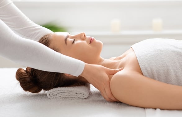 Side profile of a woman getting a massage.