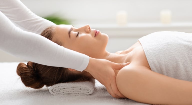 Side profile of a woman getting a massage.