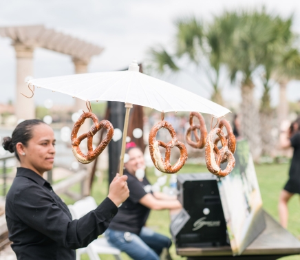 Pretzels attached to an umbrella for a fun snack during wedding reception.