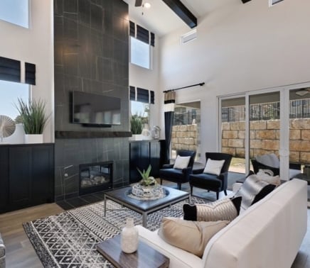 private home living room with couch two chairs, fireplace and television at Hoseshoe Bay Resort