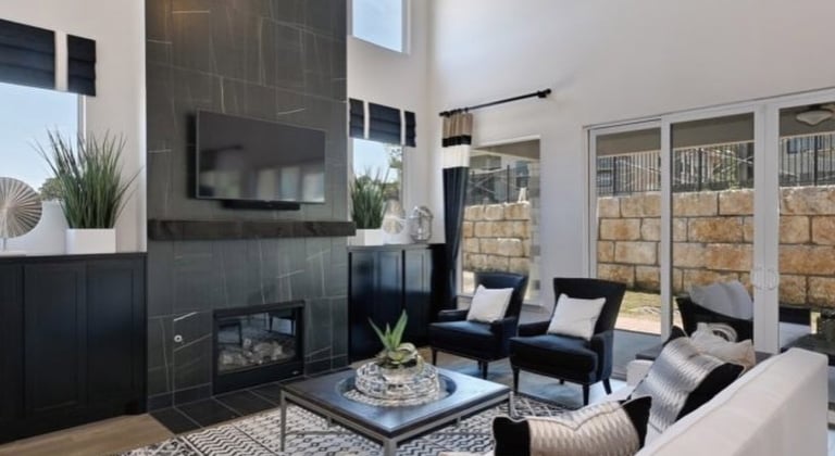 private home living room with couch two chairs, fireplace and television at Hoseshoe Bay Resort