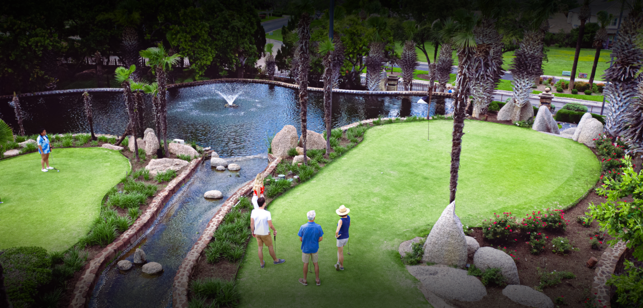 guests enjoying golf infront of fountain