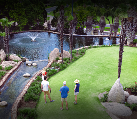 guests enjoying golf infront of fountain