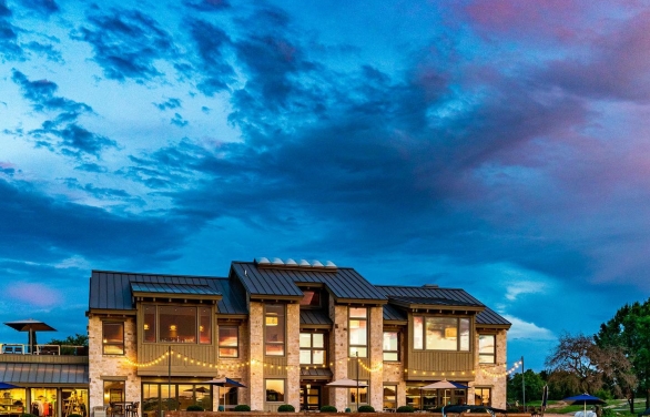 Lakeside bar and grill with beautiful blue and purple sunset setting.