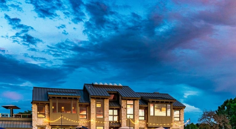 Lakeside bar and grill with beautiful blue and purple sunset setting.