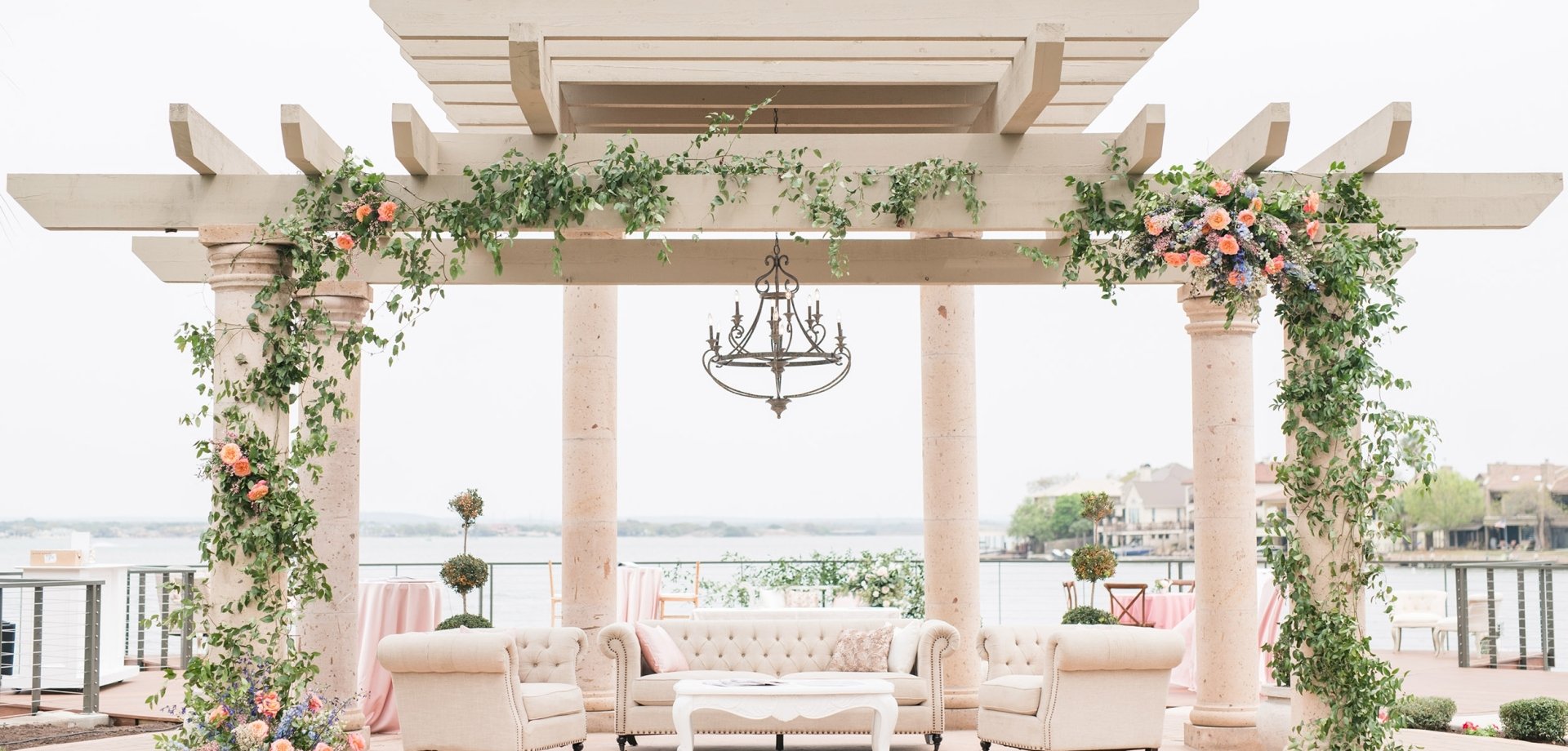 venue space in the Texas Hill Country. Large Arch with flowers overlooking the water.