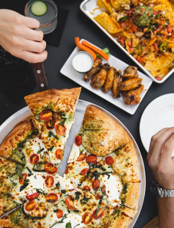 guests enjoying pizza and wings