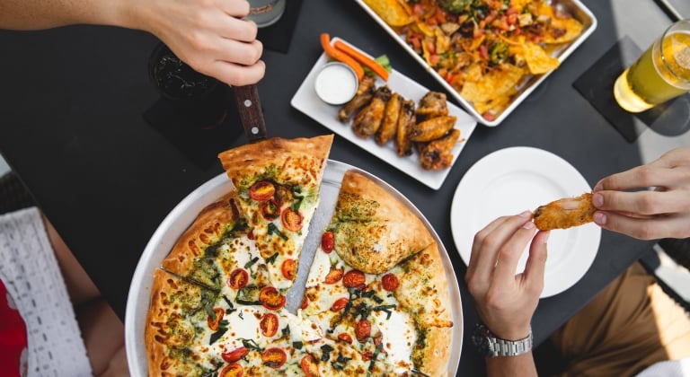 guests enjoying pizza and wings
