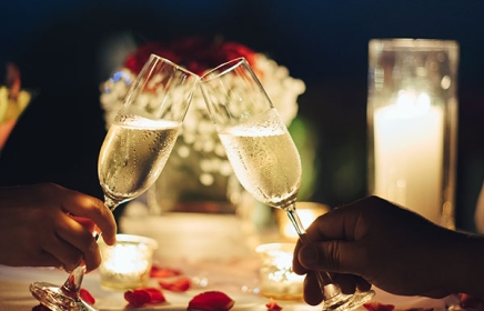 two guests cheering with champagne