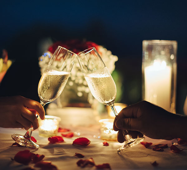 two guests cheering with champagne
