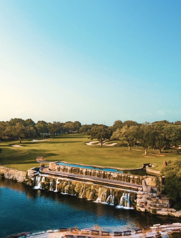 a golf course at horseshoe bay resort on a sunny day with trees and water