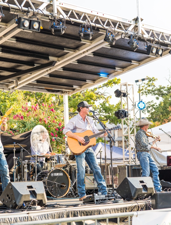 group of people performing on stage for the beer by the bay 2022 concert at horseshoe bay resort