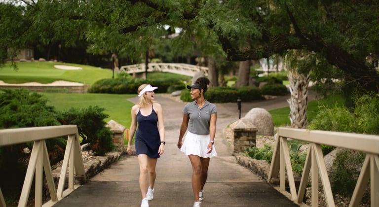 women walking through a golf course at horseshoe bay resort