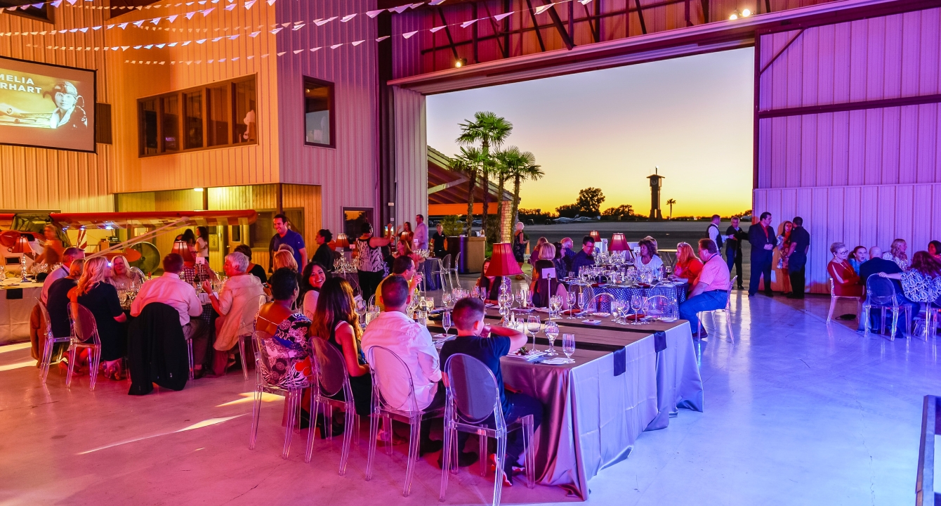 Event held at one of our signature golf courses, Cap Rock. People are enjoying food and drink at tables.