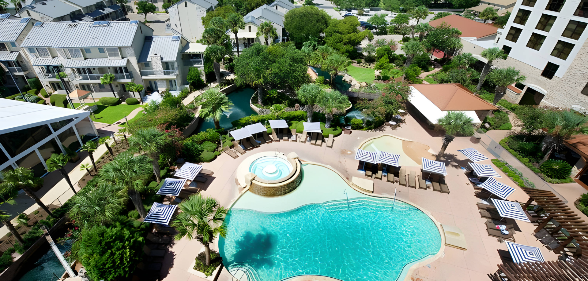 Birds eye view of Horseshoe Bay Resort pool surrounded by trees and the hotel.