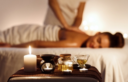 Woman getting aromatherapy massage with oils and scents.