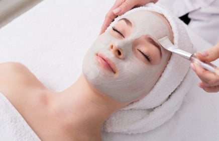 A woman getting a signature facial with a brushing technique
