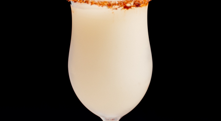 Pina Colada rimmed with tajin and loaded with summer flavor.