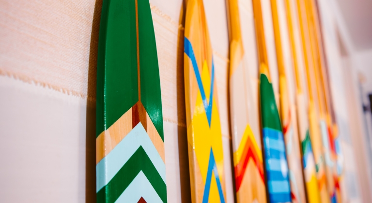 Painted canoe paddles on the wall for decoration