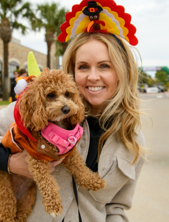 A close up of a woman holding her small dog