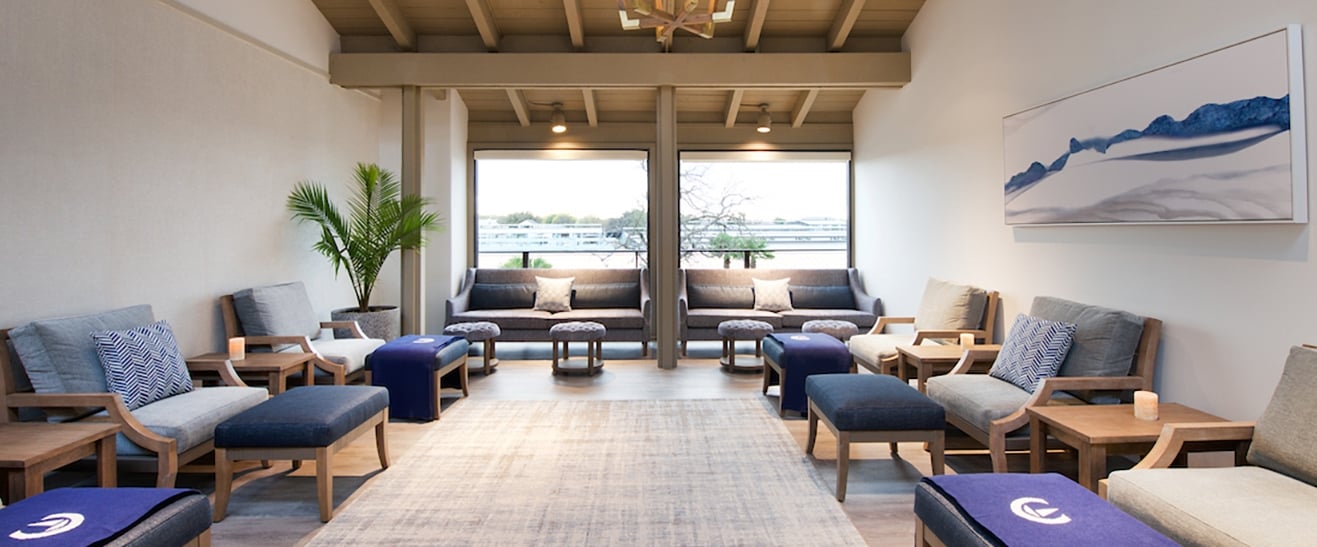 Relaxation room filled with comfortable chairs and side tables.