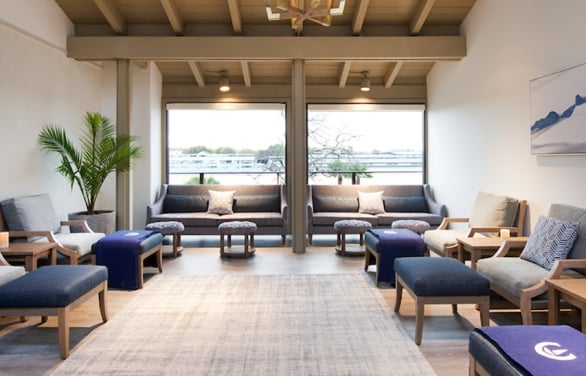 Relaxation room filled with comfortable chairs and side tables.