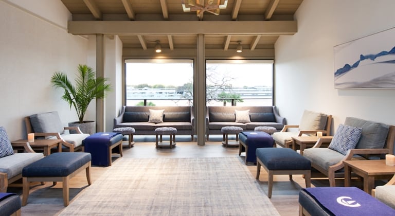 Relaxation room filled with comfortable chairs and side tables.
