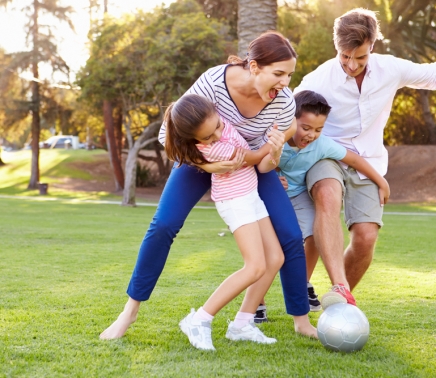 Family,Playing,Soccer,In,Park,Together