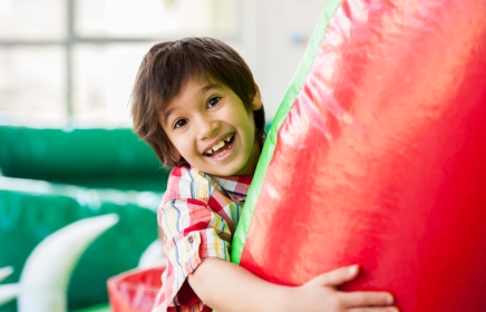 Young boy hugging a inflatable fun toy