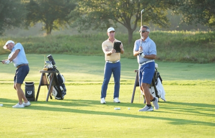 Golf coach watching a student tee off at the Golf Academy at Horseshoe Bay Resort