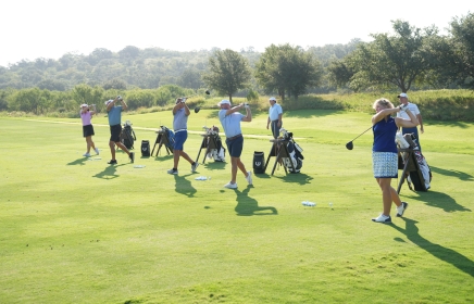 Coaches watch their students tee off at the Golf Academy at Horseshoe Bay Resort