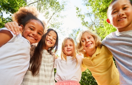 Kids smiling down looking at the camera