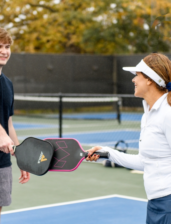 A man and woman playing Pickle Ball at Horseshoe Bay Resort