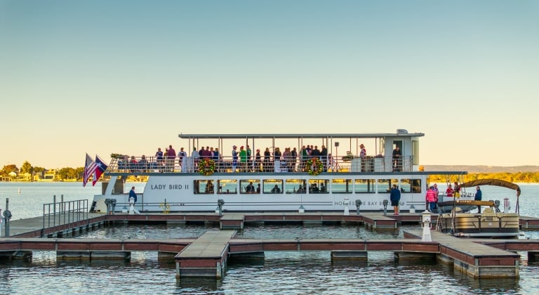 large group of people on the lady bird II docked at the marina