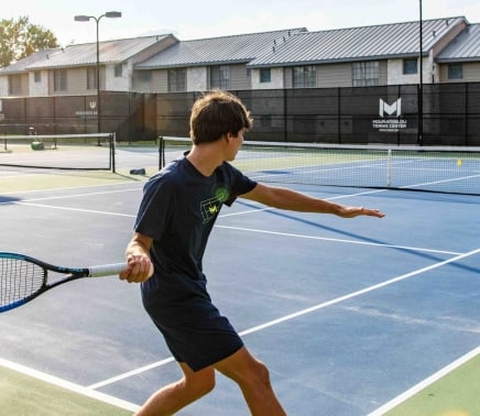 People enjoying a game of tennis at Horseshoe Bay Resort