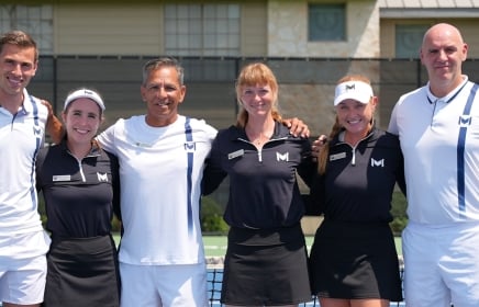 A group of people posing for a photo on the Mouratoglou Tennis Center at Horseshoe Bay Resort