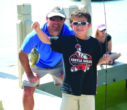 Father and son on a pier fishing