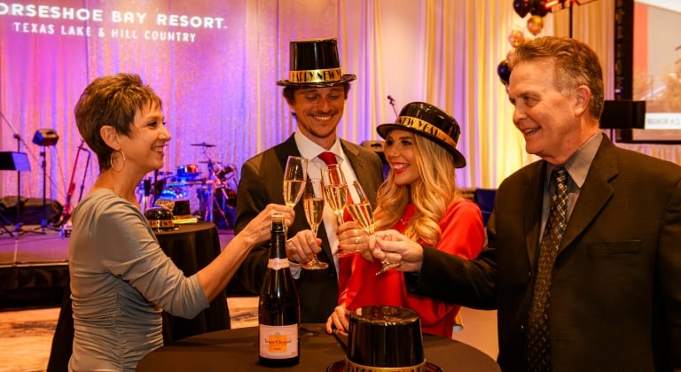 group-of-people-cheers-at-horseshoe-bay-resort-new-years-eve-bash-2024