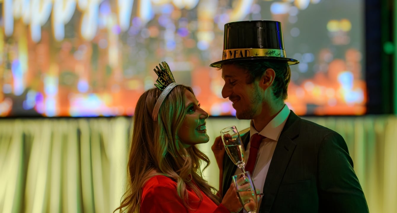 Couple-in-front-of-New-years-eve-sign