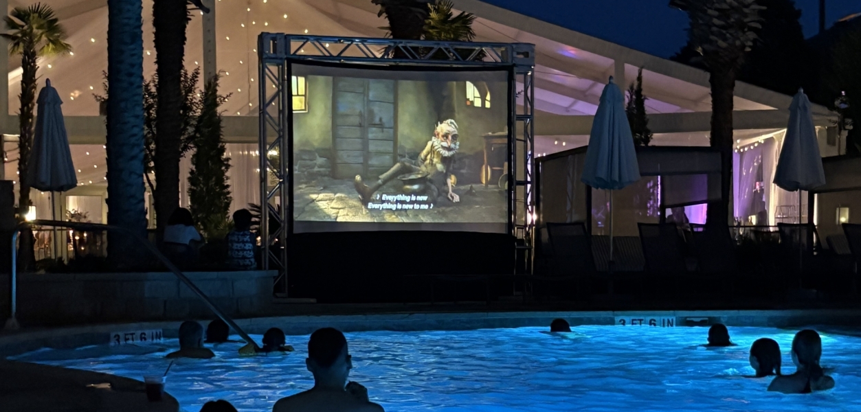people enjoying a outdoor movie while sitting in a pool at horseshoe bay resort