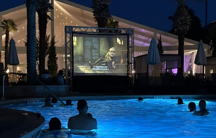 people enjoying a outdoor movie while sitting in a pool at horseshoe bay resort