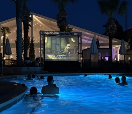 people enjoying a outdoor movie while sitting in a pool at horseshoe bay resort