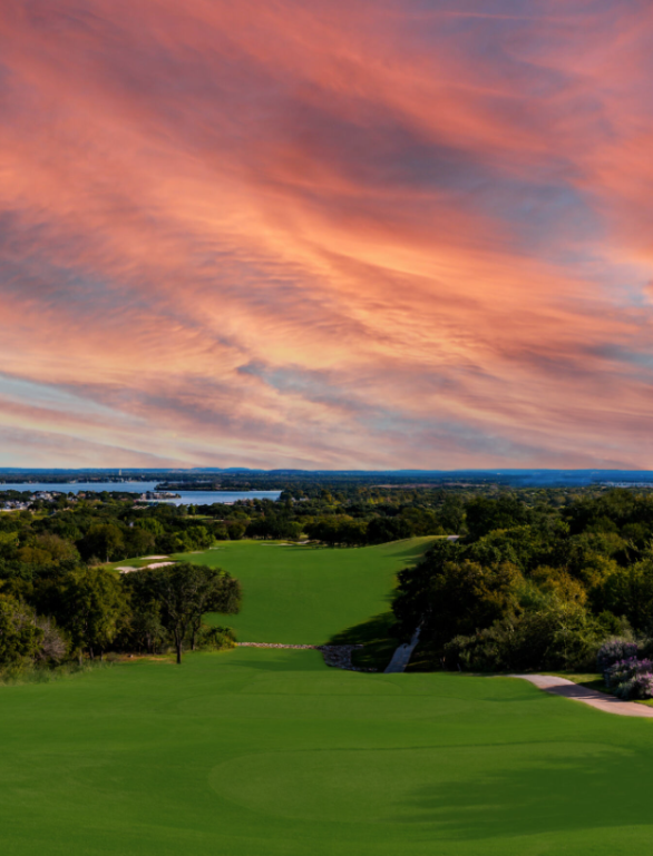 a golf course at horseshoe bay resort with the beautiful sun set in the background