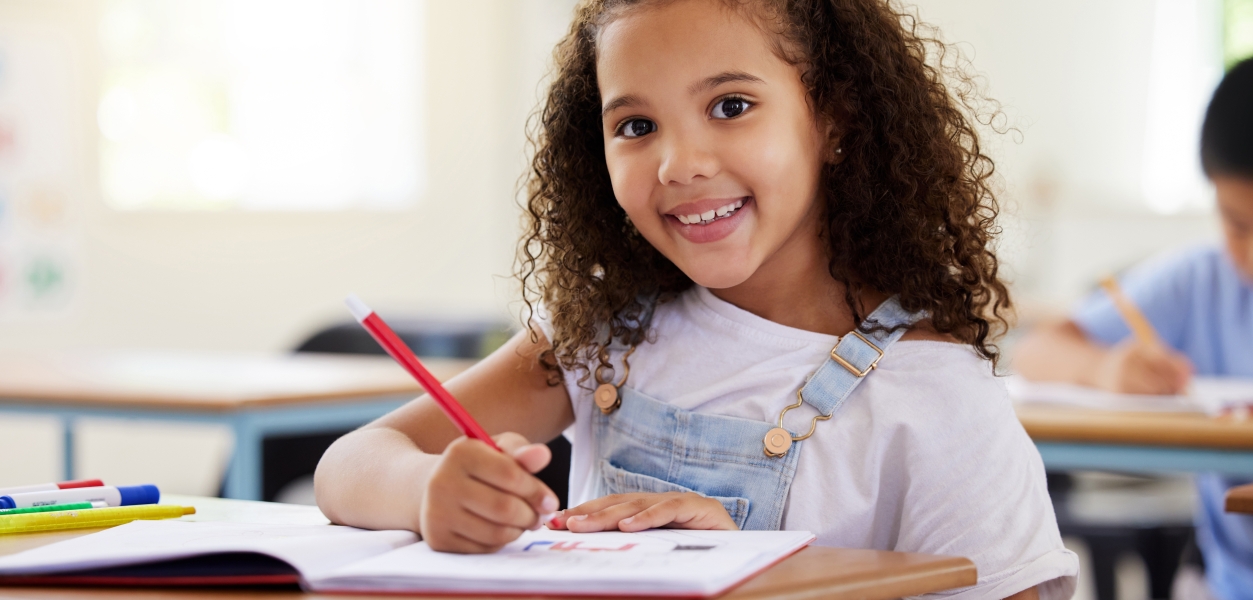 a girl sitting at a desk learning how to draw cartoons at horseshoe bay resort