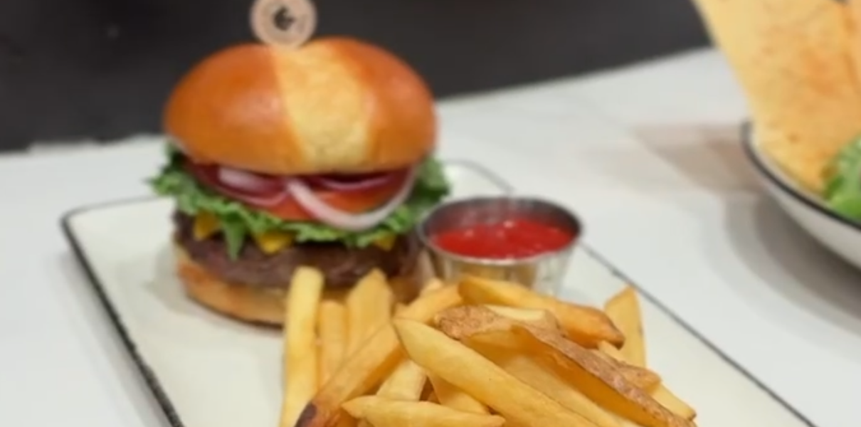 close up of a burger and fries on a plate prepared by horseshoe bay resort