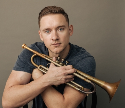 close up of Ilya Serov holding a trumpet at horseshoe bay resort
